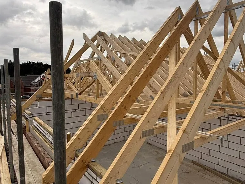 Trussed roof set out across new blockwork walls before bracing