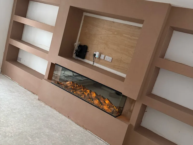 Completed media wall with an electric fire and fitted shelving