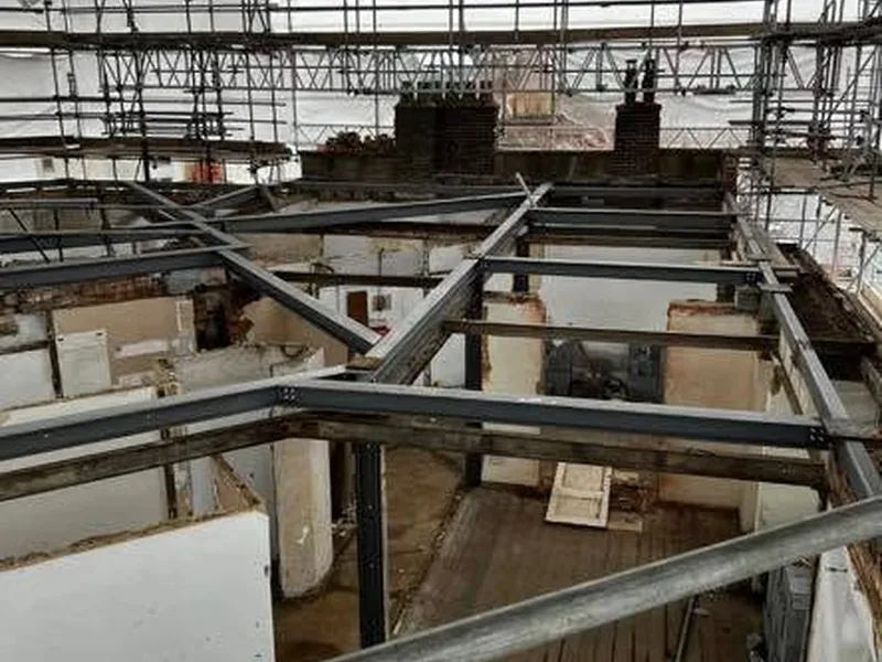 New steel beams installed over a stripped out building with the roof removed