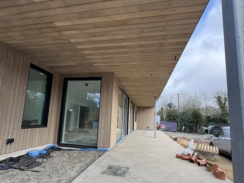 Timber clad elevation with a timber lined canopy soffit over a new walkway
