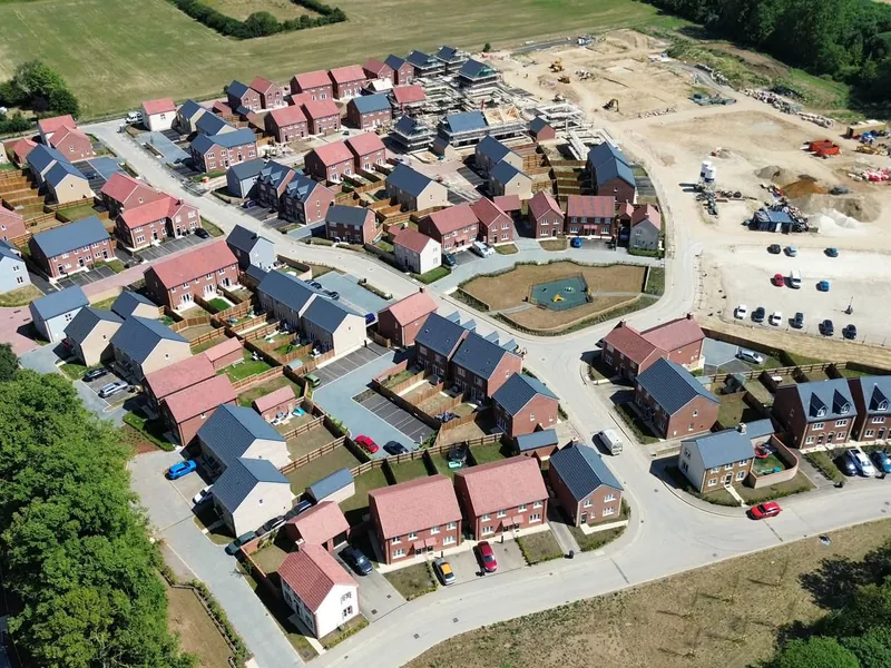 Completed homes standing alongside plots still in build on the 300 home site