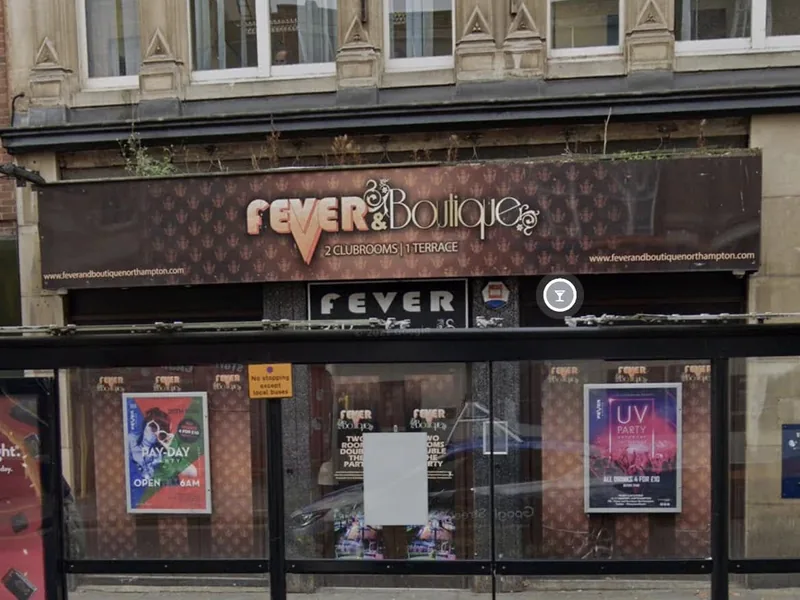Disused town centre nightclub frontage with old signage before conversion works