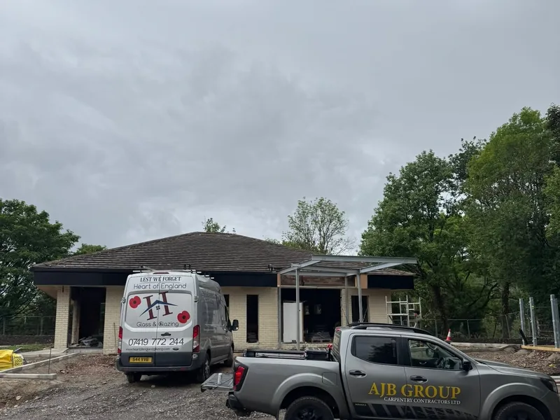 Single storey building under refurbishment with an AJB Group pickup parked outside
