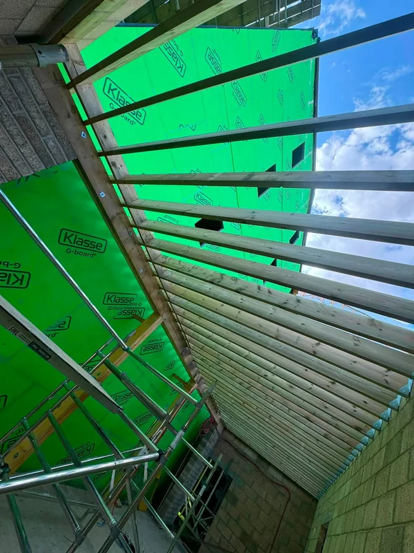 Looking up through the open joists of the cycle store roof before decking