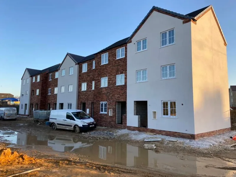 Completed three storey rendered and brick apartments on a new build site