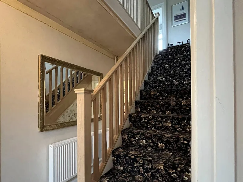 Timber staircase and balustrade with spindles in a refurbished hallway