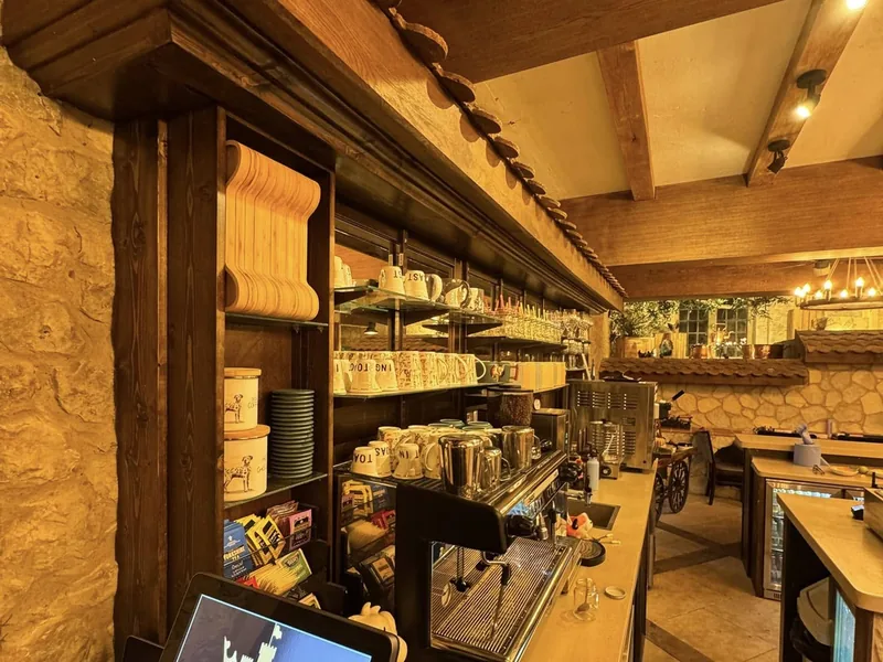 Oak shelving and beams above the servery counter in the finished cafe
