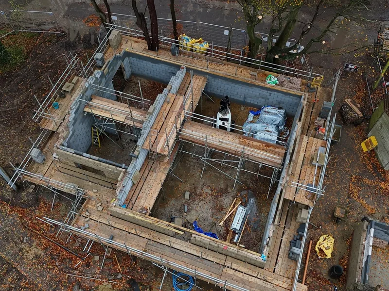 Aerial view of blockwork walls and timber beams over a new basement structure
