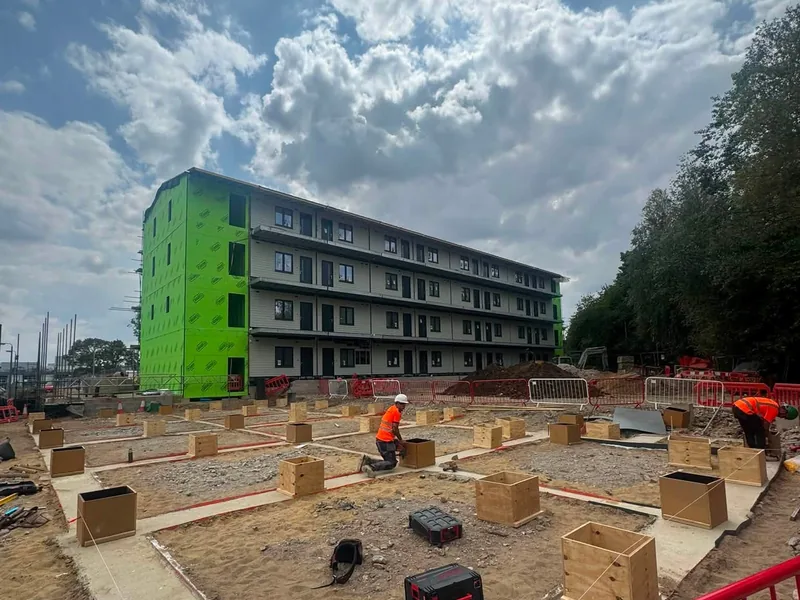 Four storey ZED Pod staff accommodation block standing behind the shutter boxes AJB Group installed at Hinchingbrooke