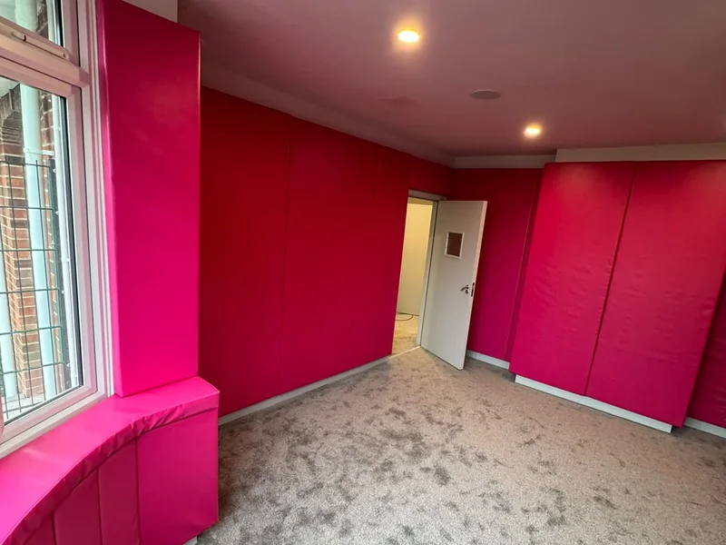 Completed lounge with bespoke fitted seating and feature panelling