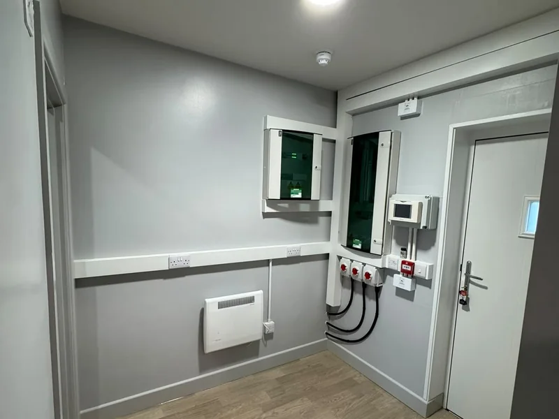 Completed room with wall mounted services panels, electric heater and a new door set