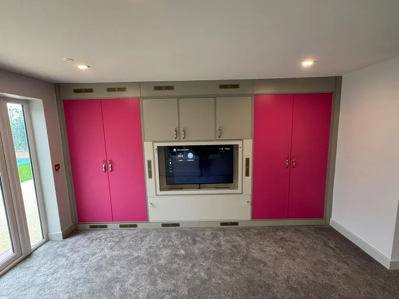 Completed activity room with fitted media wall and storage joinery