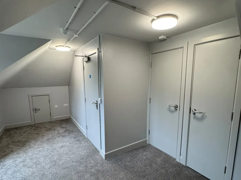 Completed first floor landing with new door sets under the existing roof pitch