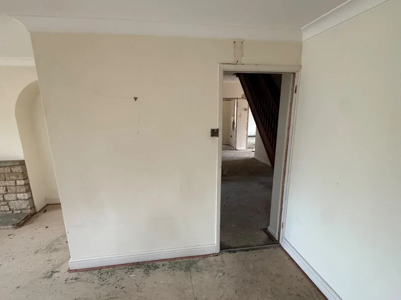Existing hallway and arched opening before the internal strip out