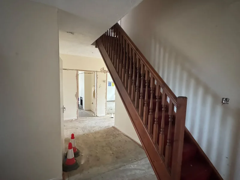 Existing staircase and red carpet before the refurbishment