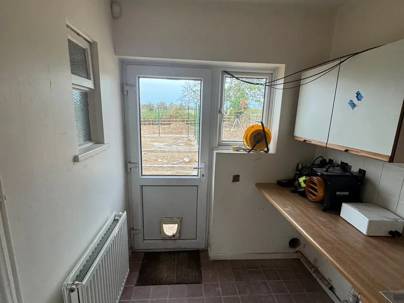 Original kitchen and rear door before the fit out