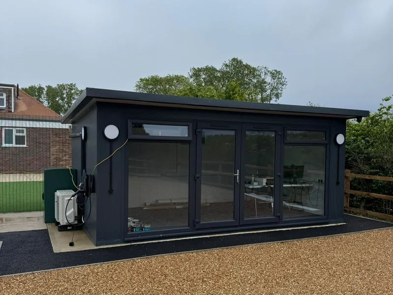 Completed black clad garden building with bifold doors
