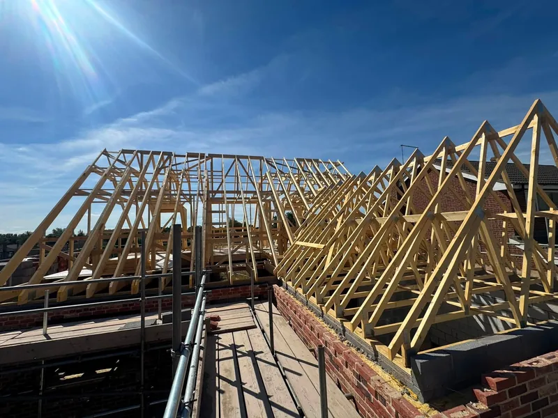 Attic trusses standing on the brickwork at scaffold level in Rippingale