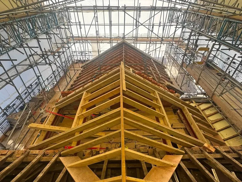 Hand cut roof structure with rafters and hips