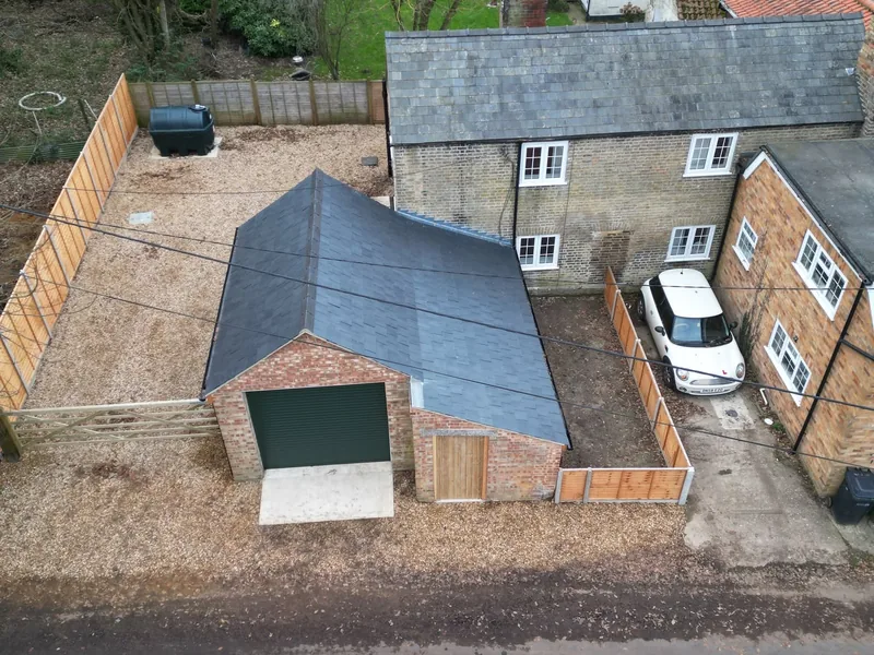 New slate roof and extension photographed from the air after completion