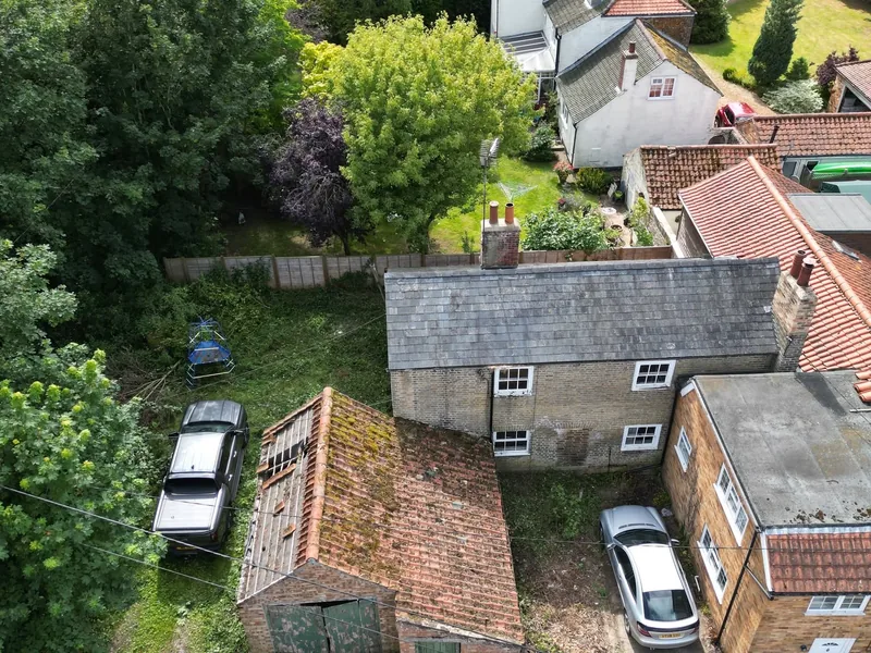 Drone view of a completed house roof and grounds