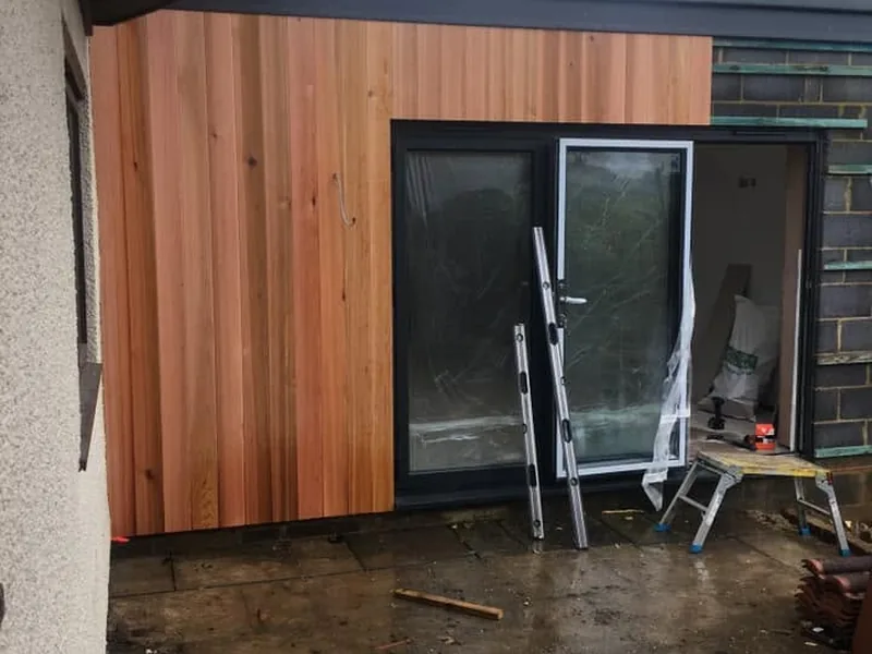 Timber clad extension complete with the ground to be finished
