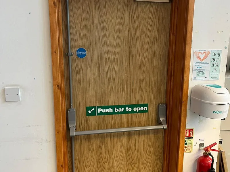 Fire door with panic bar and keep shut signage in a commercial building