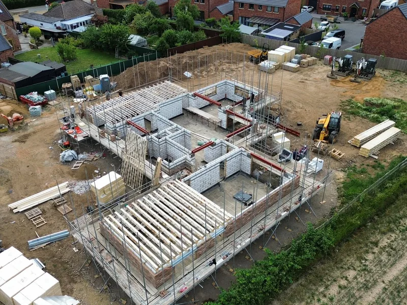 Aerial view of a new build with first floor joists and steels set over blockwork walls