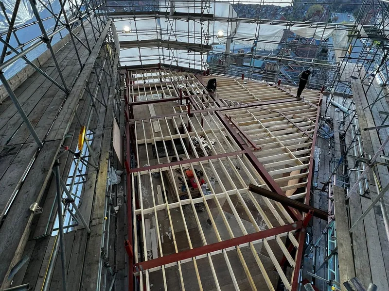 Roof steels and timbers set within the scaffold before decking