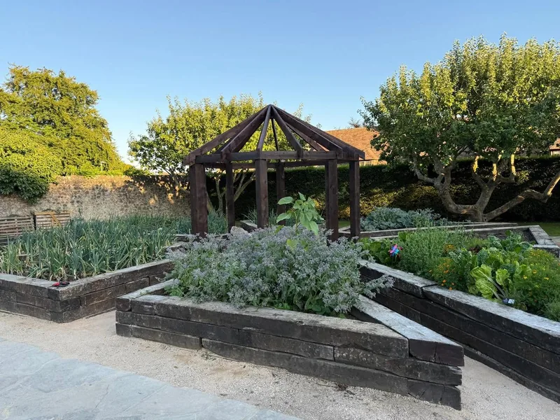 Timber pergola built over a kitchen garden with raised beds