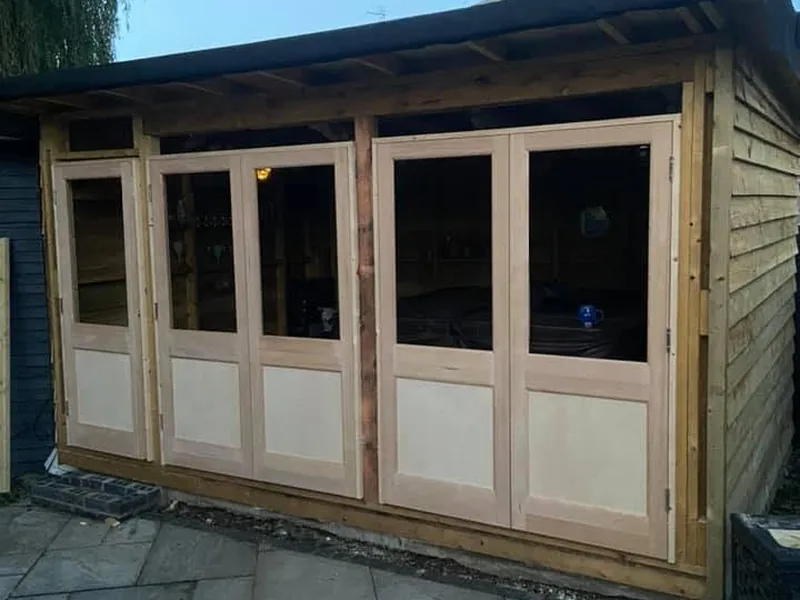 Bespoke timber bifold doors on a garden room made and fitted on site