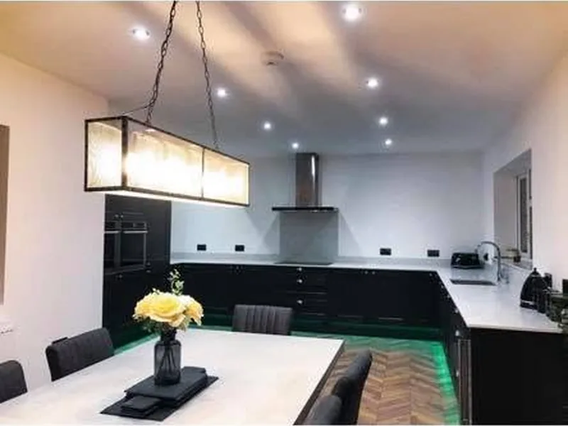 Fitted kitchen diner with island and pendant lighting installed by AJB Group