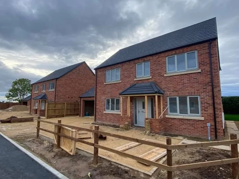 Completed new build house with post and rail fence