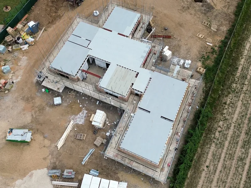 Aerial view of a new build with insulation boards laid across the ground floor inside blockwork