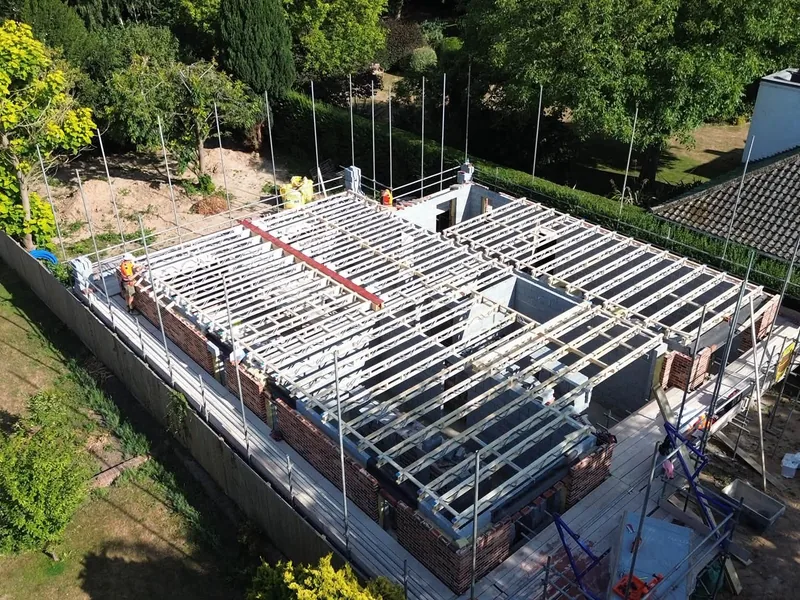 Aerial view of a metal web joist set installed to form a first floor over brickwork