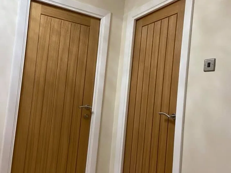 Oak internal doors hung and trimmed in a hallway