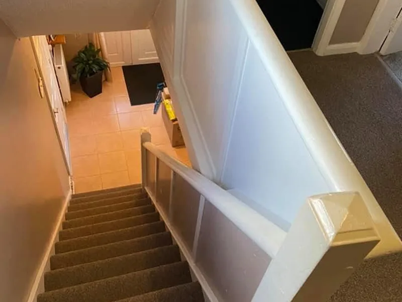 Painted staircase and landing balustrade in a finished house