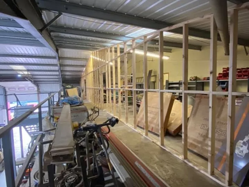 Timber stud partitions being formed inside a steel framed industrial unit