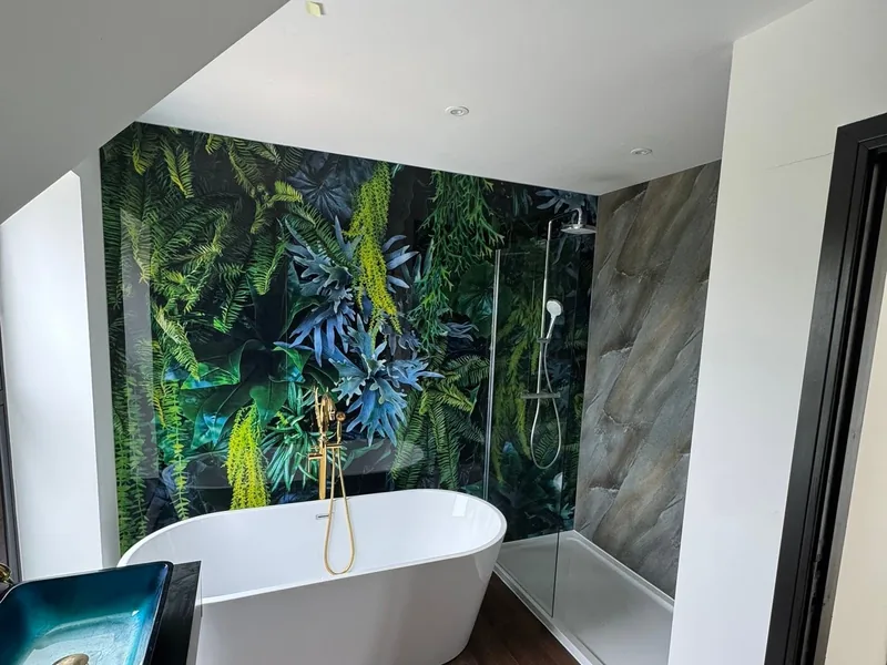 Finished bathroom with a freestanding bath, walk in shower and tropical print feature wall