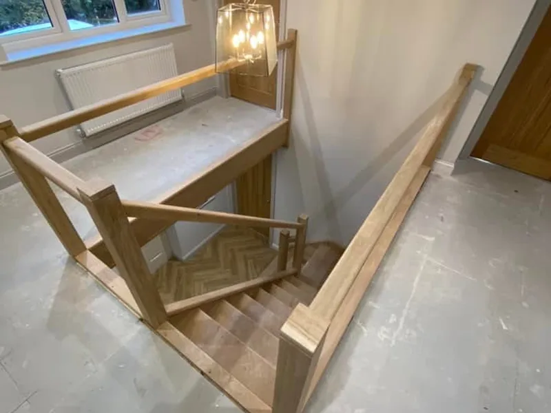 Oak stair and landing balustrade part way through installation