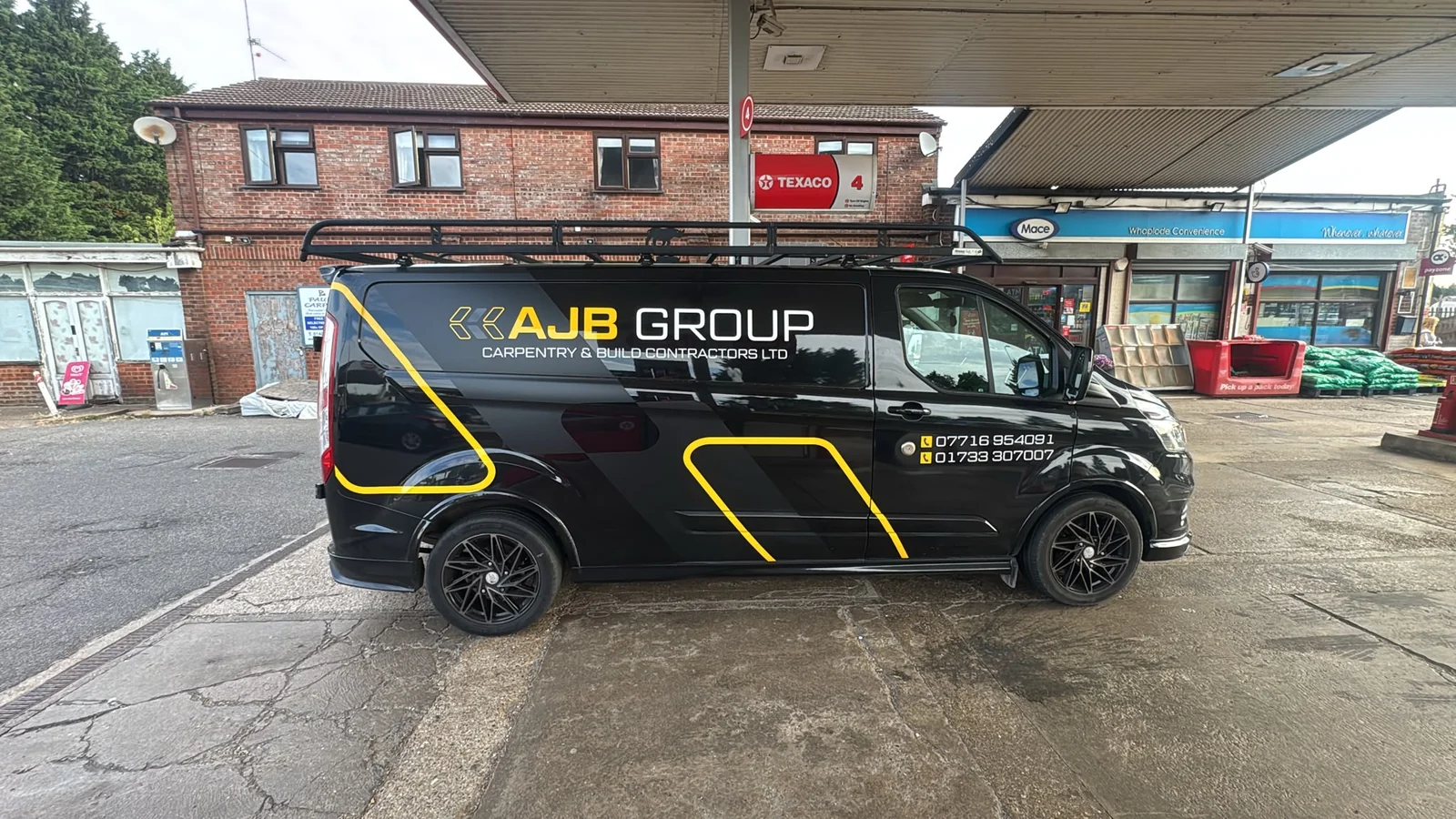 AJB Group branded Ford Transit van with roof rack and yellow livery, Lincolnshire