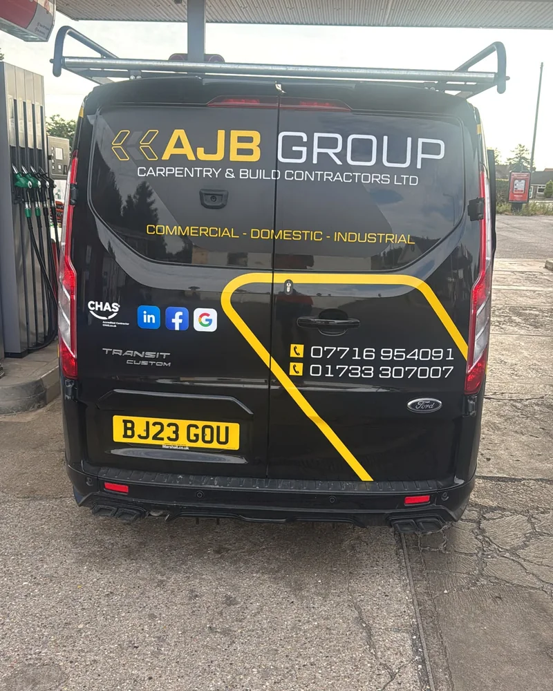 Rear of an AJB Group branded Ford Transit van in black and yellow livery
